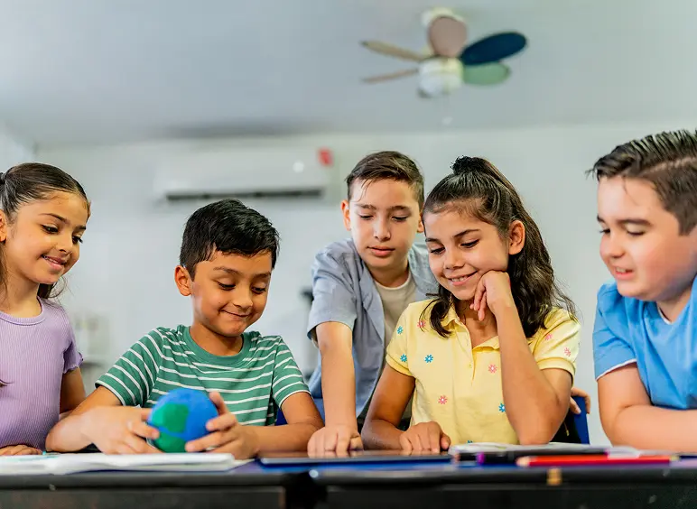 Three children engaged in a fun learning activity at school.