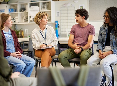 Teacher and students in classroom discussion